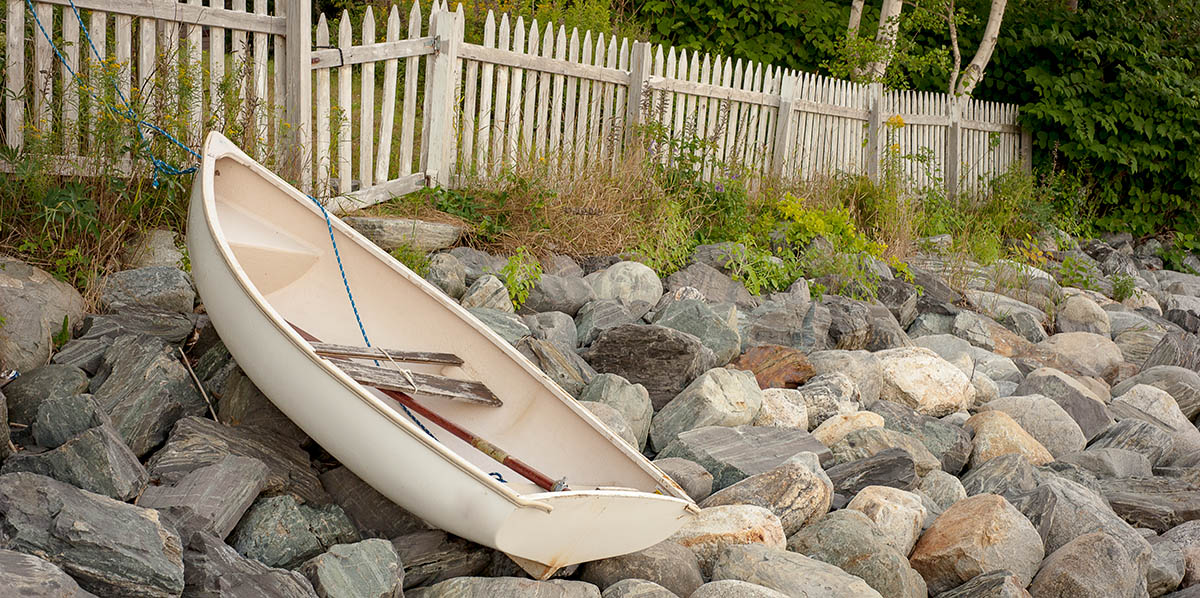 dinghy rests on a rocky Maine beach