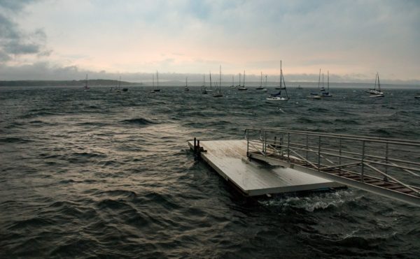 swimming float at bayside dock rocks on stormy water