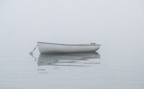 moored dinghy on a foggy day
