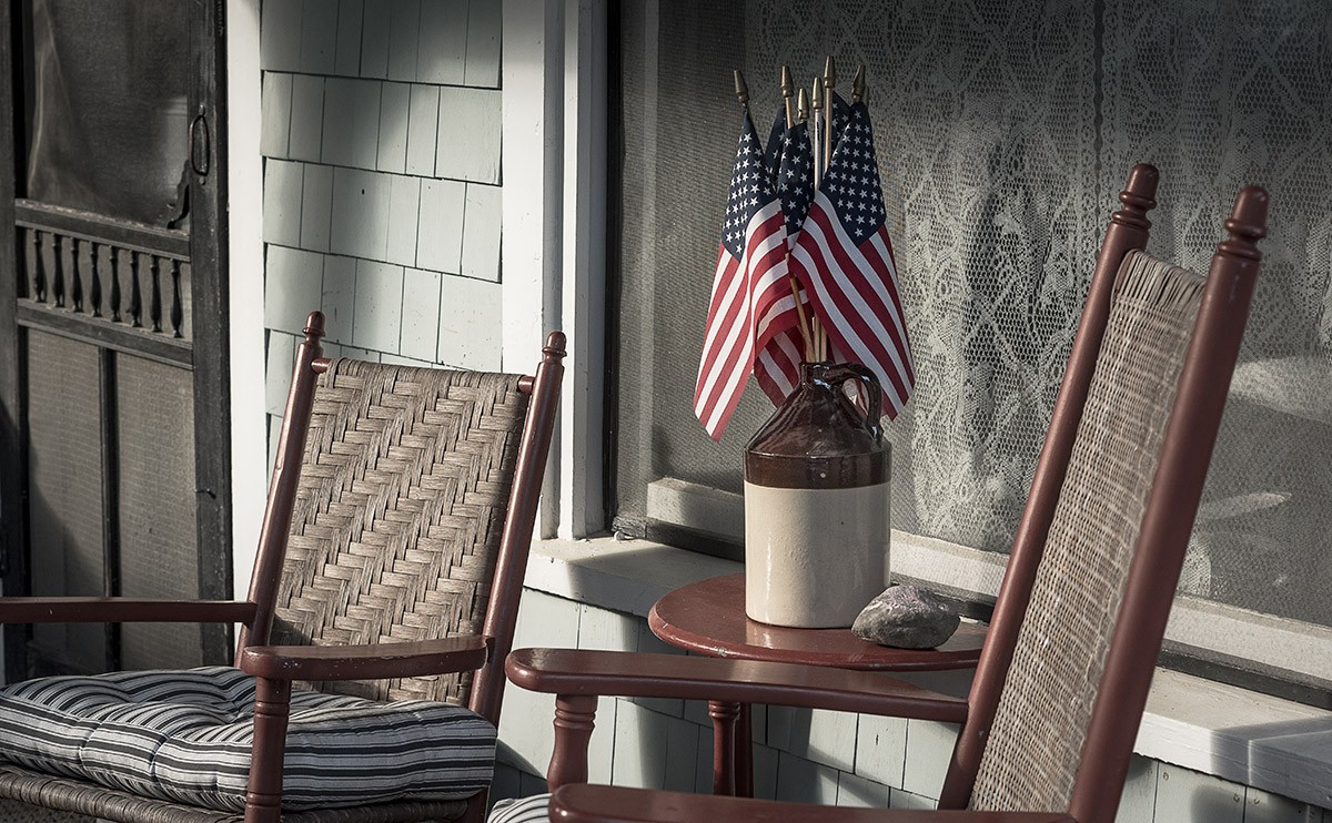Small flags arranged like a flower arrangement on a summer cottage porch