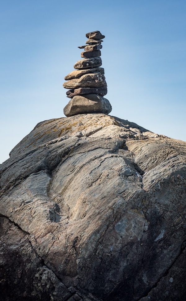 Small stone cairn built on top of a large boulder