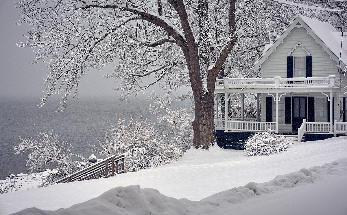 white cottage surrounded by snow