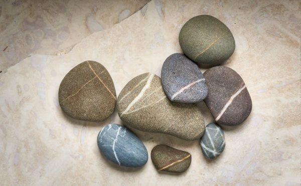 arrangement of striped beach stones on a stone background